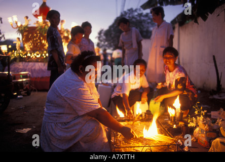 Philippines, Panay Island, Woman lights  candles at Ati-Atihan Festival in city of Kalibo Stock Photo