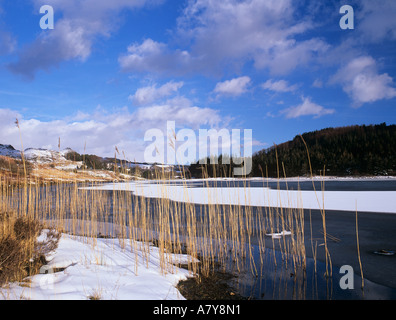 LLYNNAU MYMBYR partly frozen lake with snow in winter. Capel Curig Snowdonia North Wales UK Britain Stock Photo