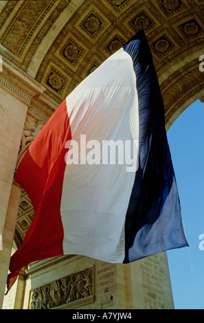 France, Paris, Etoile, French flag under Arc de Triomphe built by Napoleon to celebrate his victories Stock Photo