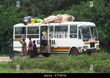 Local village bus with villagers getting off bus after a long journey from city in Western Ghana Stock Photo