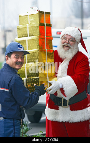 Mail Carrier Helping Santa Claus with Christmas Presents Stock Photo