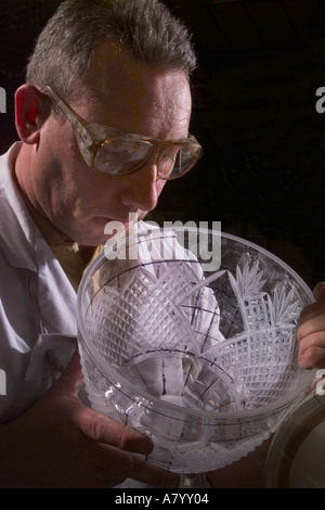 English glass craftsman polishing a cut glass crystal bowl UK Stock Photo