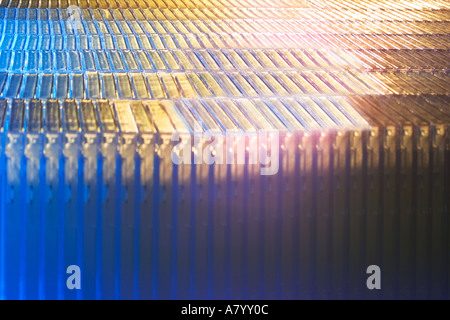 Futuristic conceptual image showing fast moving factory packaging line during production of plastic shrink wrapping around CD ROM or DVD cases in UK Stock Photo