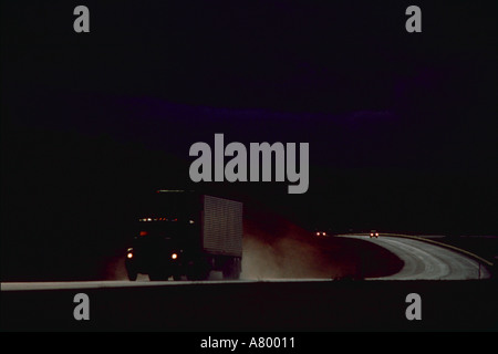 Tractor trailer truck and cars after rainstorm on I 90 highway in Montana Stock Photo