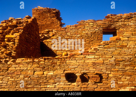 New Mexico: Chaco Culture National Historic Park, Anasazi 'Pueblo Bonito' ruin wall with three holes in foreground Stock Photo