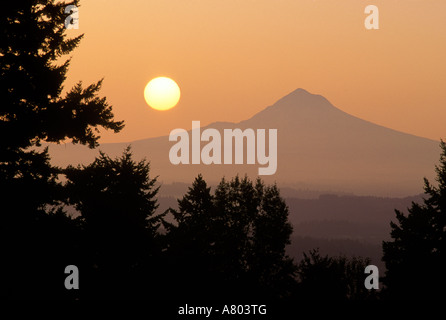 The sun hangs above Mt Hood, as viewed from Portland, Oregon. Stock Photo