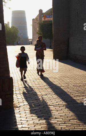 Khiva, Silhouetted People Walking Down Lane Stock Photo