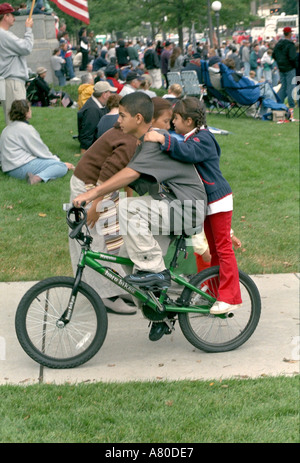 Kids age 8 and 13 biking at Minnesota Remembers 9/11 Memorial Service for victims at state capitol. St Paul Minnesota MN USA Stock Photo