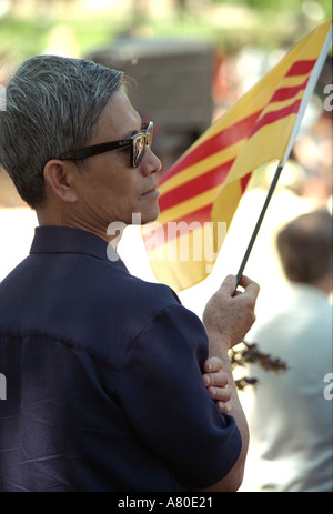 Vietnamese man holding South Vietnam flag at Memorial Day service. St Paul Minnesota MN USA Stock Photo