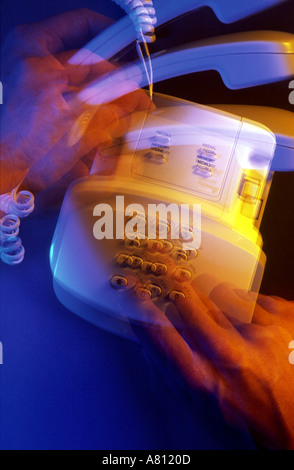 Hands picking up handset and speed dialing telephone,activity,active,access,accessibility, Stock Photo