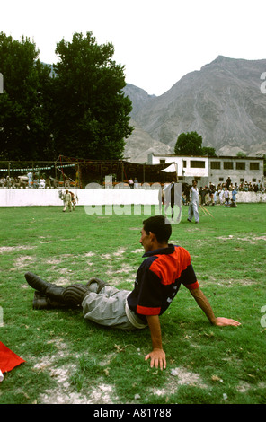Pakistan sport Azad Kashmir Gilgit player sitting on polo field before game Stock Photo