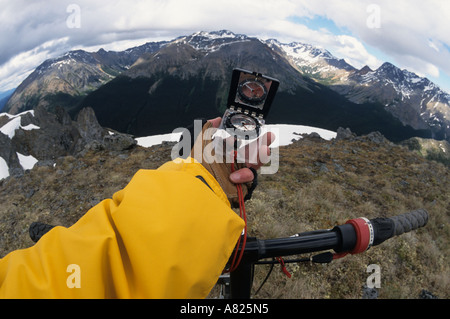 Mountain biker using compass Babine Mountains Provincial Park British Columbia Stock Photo