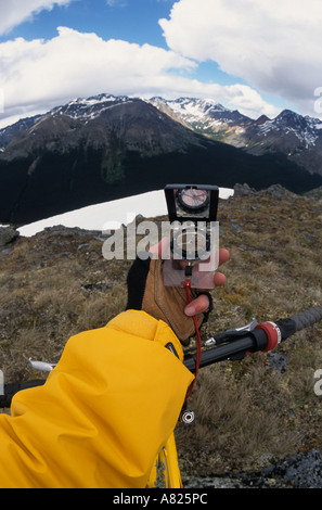 Mountain biker using compass Babine Mountains Provincial Park British Columbia Stock Photo