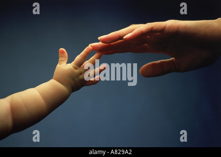 Mother and child reaching for each other love touching tenderness