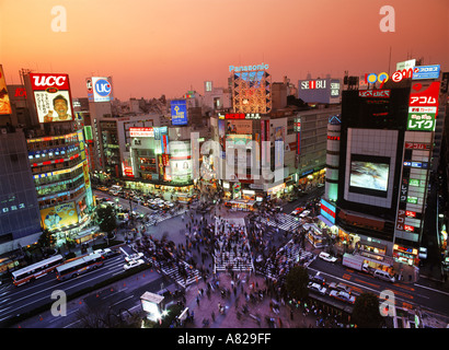 Above Shinjuku storefronts and traffic at dusk in Tokyo Stock Photo