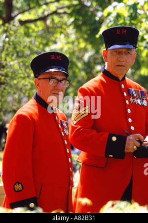 Two Chelsea Pensioners at the annual Chelsea Flower Show in the grounds of Royal Hospital Chelsea London England Stock Photo