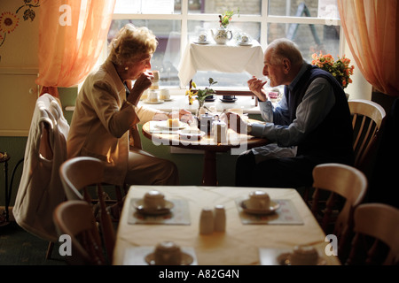 The town of Stow on the Wold in Gloucestershire UK An elderly couple enjoy afternoon tea in "Freebus" in Digbeth Street Stock Photo