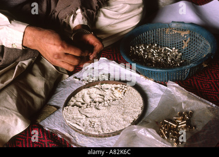 Pakistan NWFP Darra Adam Khel hands of man making pistol bullets Stock Photo