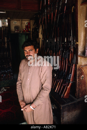 Pakistan NWFP Darra Adam Khel man in shop selling locally made guns Stock Photo