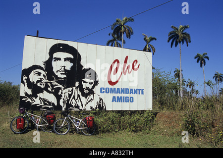 Touring bikes leaning against a billboard of Che Guevara, Cuba Stock Photo