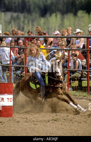 A lady barrel racer rounding a barrel Stock Photo - Alamy