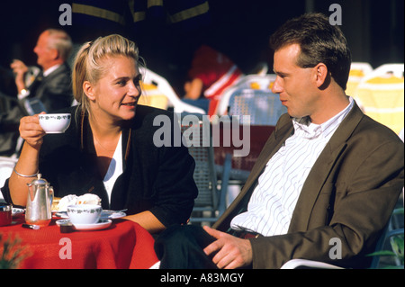 A german couple having coffee at an outdoor cafe Stock Photo
