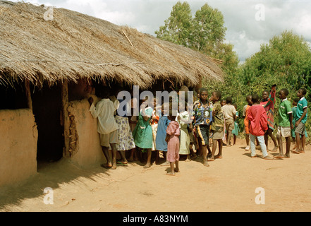 Group of village children gathering around a school hut in Malawi, East Africa. Stock Photo