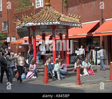 People resting around a pagoda in Chinatown, London, England Stock Photo