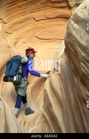 Man hiking in slot canyon in winter Goblin Valley State Park Utah Stock Photo