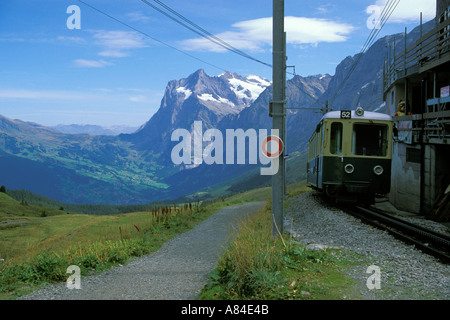 Cog train arriving in Grindelwald Valley Weterhorn Mountain in background Klien Sheidegg Swiss Alps Switzerland Stock Photo