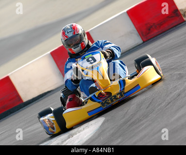A  kart racer negotiates an extreme high-speed turn. Stock Photo