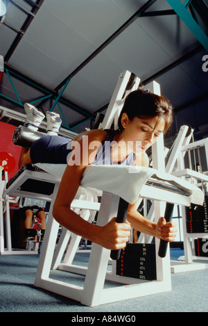 Young woman fitness training in gymnasium. Stock Photo