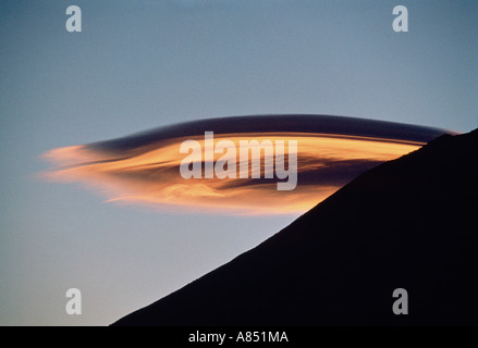 Unusual cloud formation. Evening light above silhouetted mountain ridge. Nepal. Mount Everest. Stock Photo