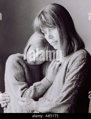 Indoor portrait of mother and daughter sitting together. Stock Photo