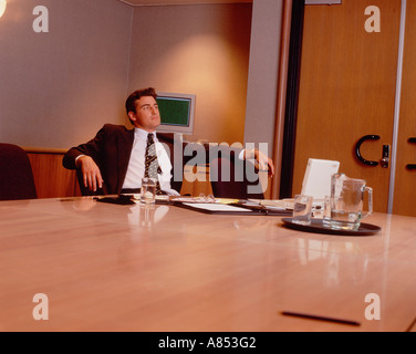 Thoughtful business man alone in office. Stock Photo