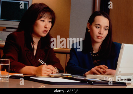 Closeup if  two women working in an office. Stock Photo