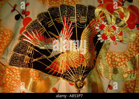 Close-up of fan and bird design printed and embroidered on Japanese silk kimono. Stock Photo
