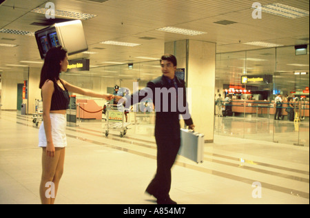 Young couple inside Singapore airport. Stock Photo