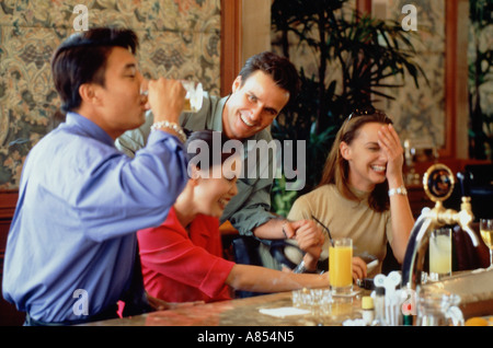 Two happy couples drinking at bar. Stock Photo