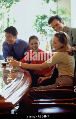 Two happy couples drinking at a bar. Stock Photo