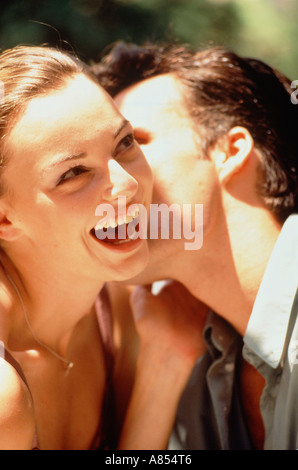 Outdoor portrait of young couple with woman laughing. Stock Photo