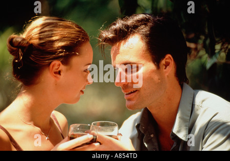Outdoor close-up of young couple in summer drinking wine. Stock Photo