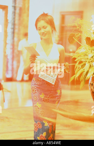 Faded impressionist image of young woman in hotel lobby. Singapore. Stock Photo