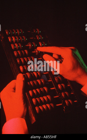 Close-up of man's hands using an abacus. Stock Photo