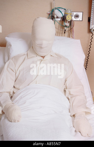 Male patient with serious burns bandaging lying in hospital bed. Stock Photo