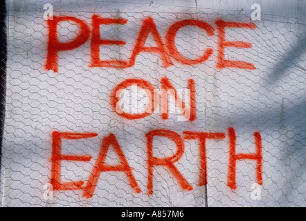 Artwork. Graffiti message painted on wall. 'Peace on Earth'. Stock Photo