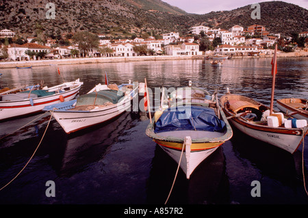 Turkey. Kas. Harbour scene with moored fishing boats and distant waterside town buildings. Stock Photo