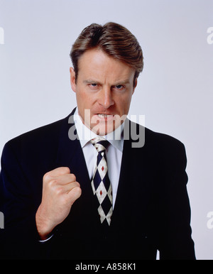 Studio portrait of young man wearing dark business suit. Stock Photo