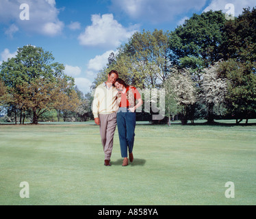 Young, romantic couple walking in the park. Stock Photo