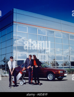 Concept of three business colleagues playing golf in office car park. Stock Photo